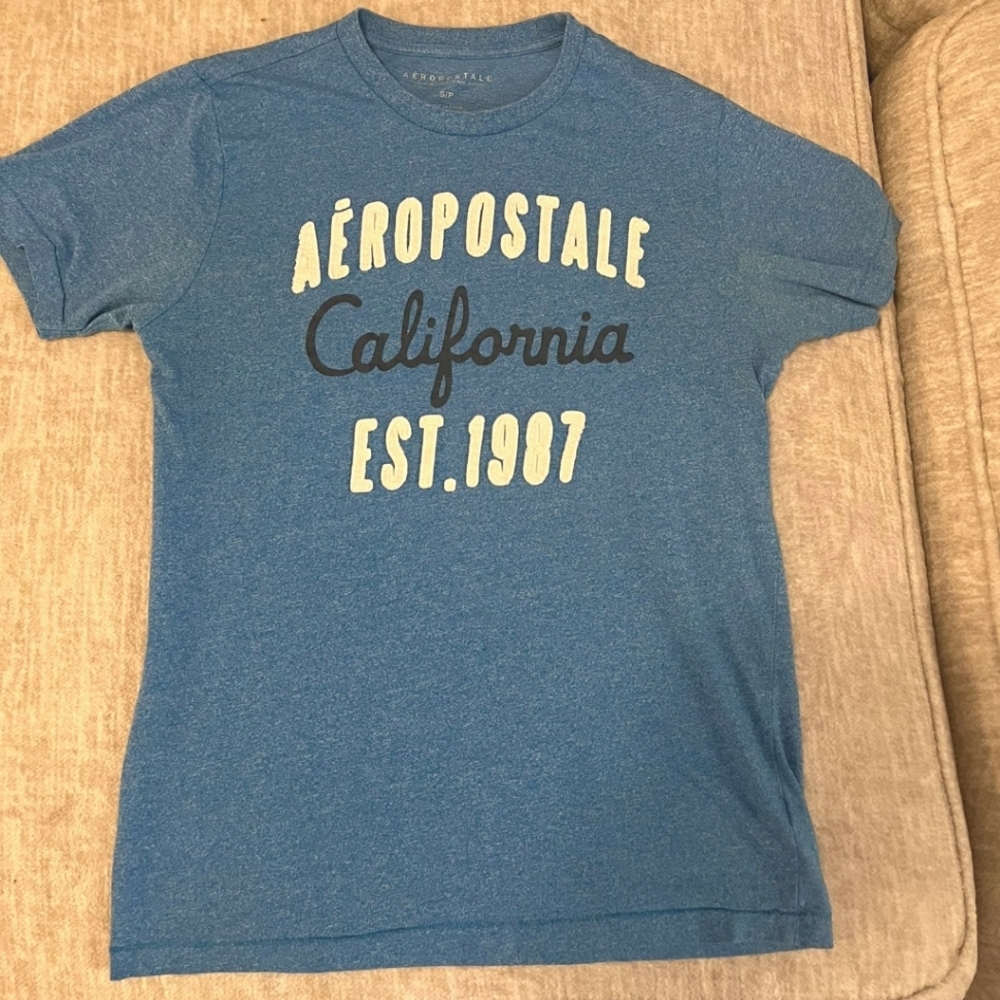 Blue t shirt with brand name logo that stands out